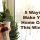 hands covered by blanket holding mug with text 5 Ways to Make Your Home Cozy This Winter